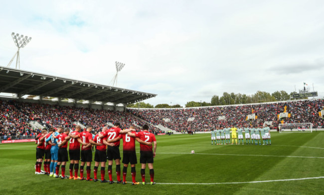 The teams observe a minute's silence