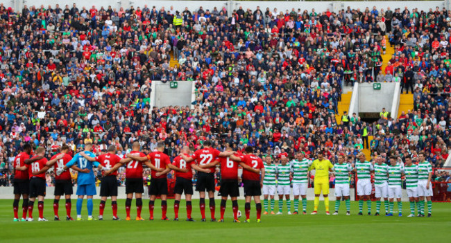 The two teams stand for a minute's silence