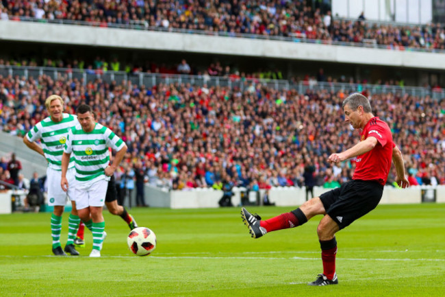 Denis Irwin scores their first goal from a penalty