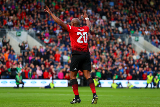 Dion Dublin celebrates scoring a penalty to win the game