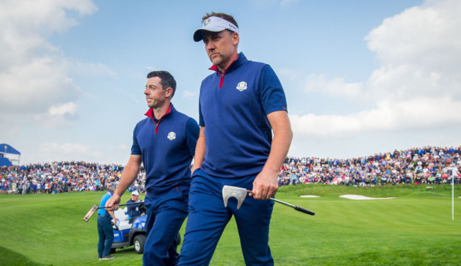 Rory McIlroy and Ian Poulter leave the 11th green