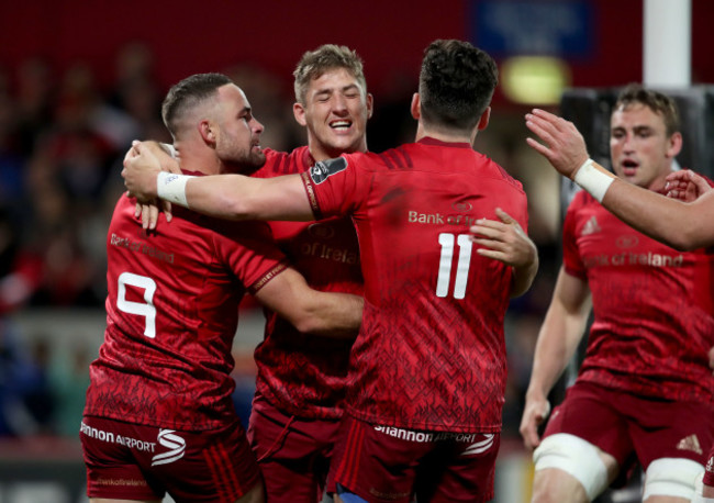 Dan Goggin celebrates a try with Alby Mathewson and Alex Wootton