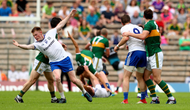 Players tangle off the ball during a kick out