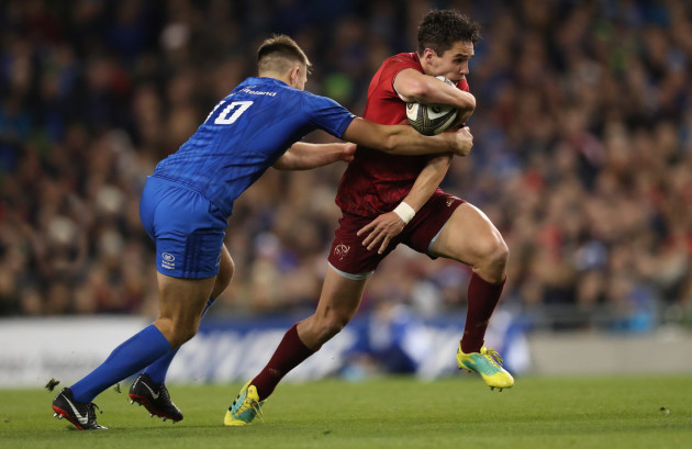 Munster's Joey Carbery is tackled by Leinsters Ross Byrne