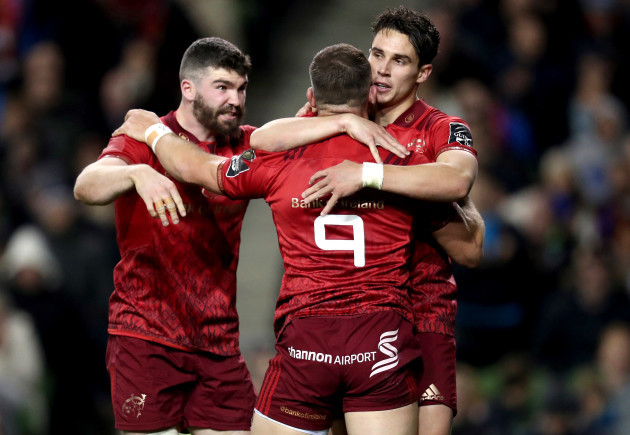 Alby Mathewson celebrates scoring a try with Dan Goggin and Joey Carbery