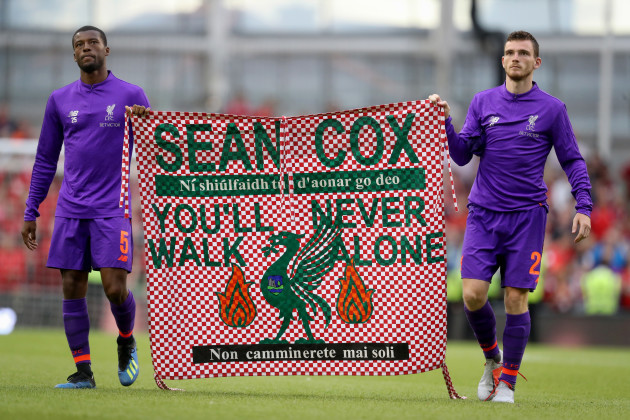 Georginio Wijnaldum and Andrew Robertson with a banner for Sean Cox after the game