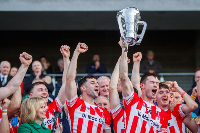 Seamus Harnedy lifts the trophy presented by Tracey Kennedy