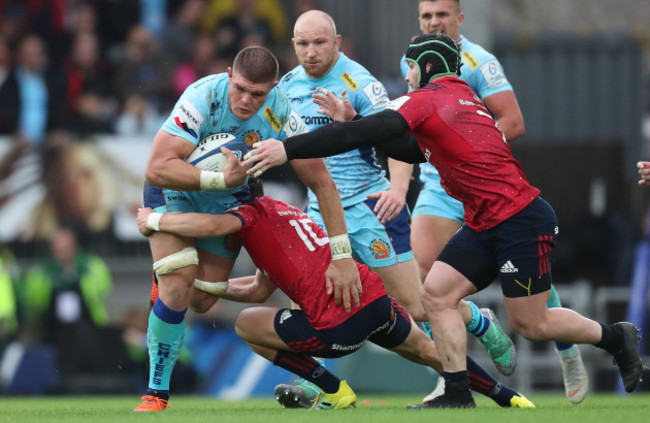 Exeter Chief's Dave Ewers is tackled by Munster's Joey Carbery and Chris Cloete