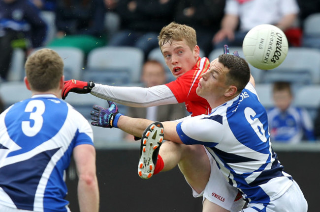 Ciaran Byrne gets his shot away despite the tackle of John O'Loughlin