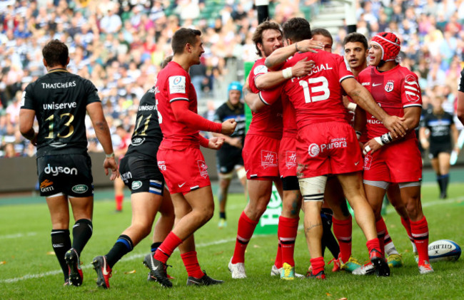 Toulouse's players celebrate with Sofiane Guitoune after he scored his sides third try