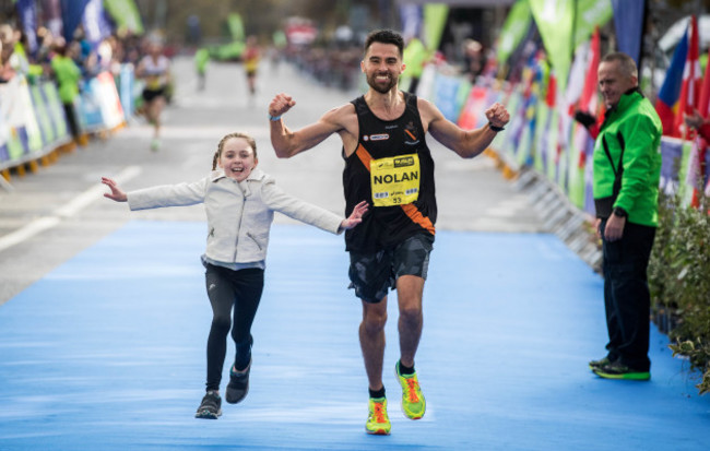 Karl Nolan crosses the line with his daughter Abigail