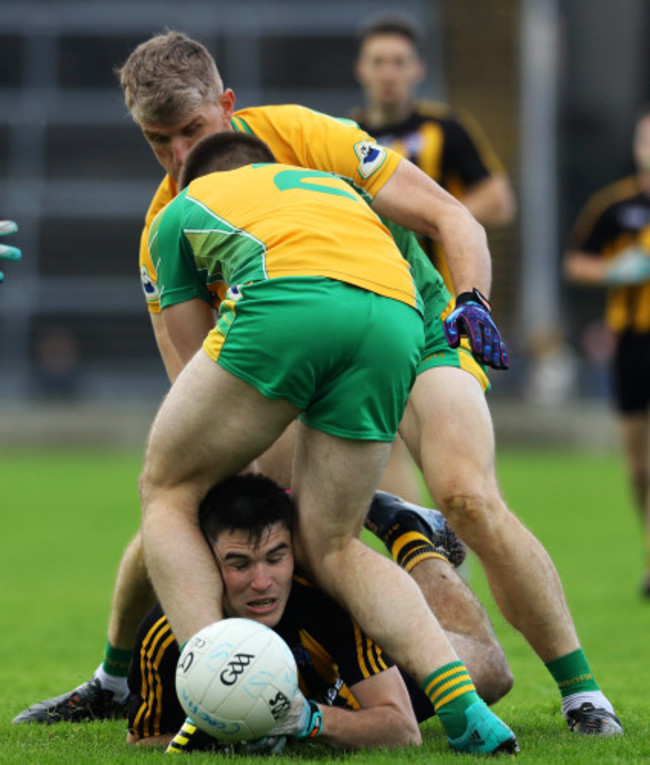 Kieran Fitzgerald and Cathal Silke tackle Barry McHugh