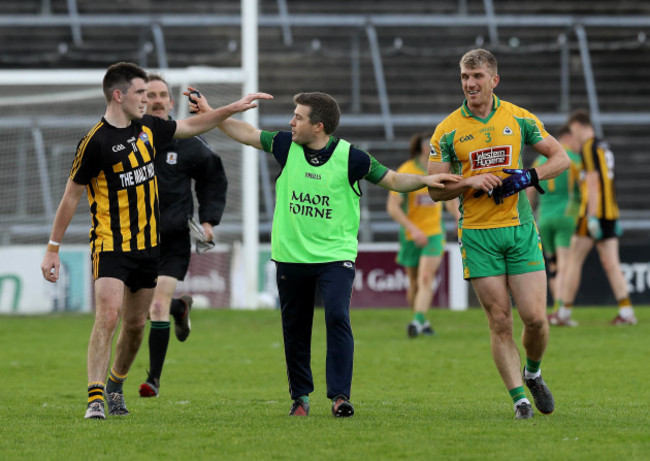Kieran Fitzgerald and Barry McHugh are kept apart by a Corofin official after both were sent off