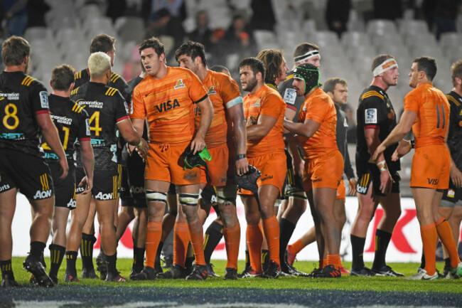 The two teams shake hands after the game