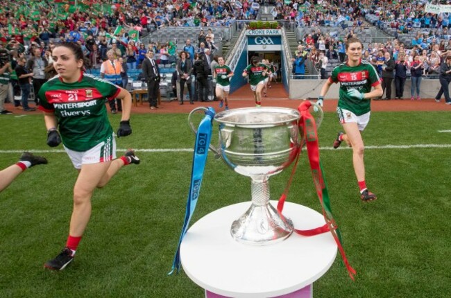 Mayo players run past the Brendan Martin Cup