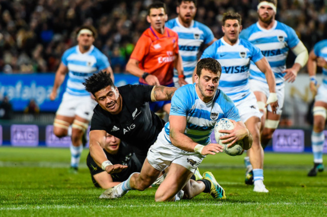 Emiliano Boffelli scores a try despite the tackle from Ardie Savea