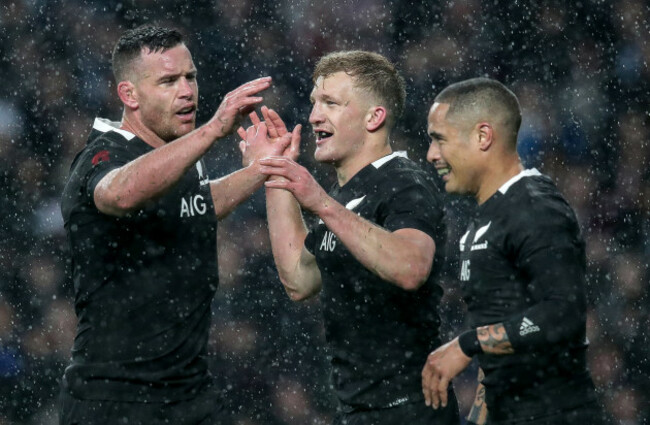 Damian McKenzie celebrates scoring his sides first try with Ryan Crotty and Aaron Smith
