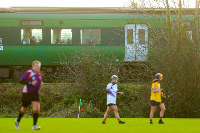 Passengers on a passing train watch on