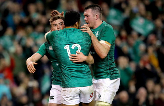 Luke McGrath celebrate scoring a try with Bundee Aki and Peter O'Mahony