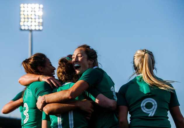 Laura Sheehan celebrates scoring a try with teammates