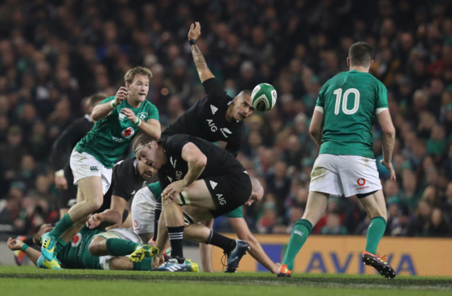 Ireland’s Kieran Marmion passes to Jonathan Sexton as New Zealand's Aaron Smith and Brodie Retallick look on