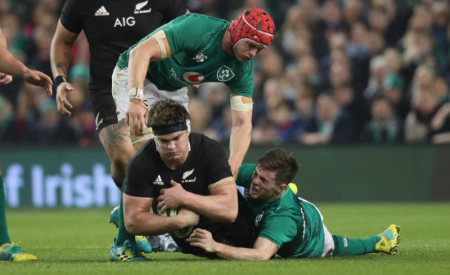 New Zealand's Scott Barrett is tackled by Ireland&rsquo;s Josh van der Flier and Luke McGrath
