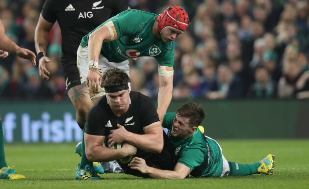 New Zealand's Scott Barrett is tackled by Ireland’s Josh van der Flier and Luke McGrath