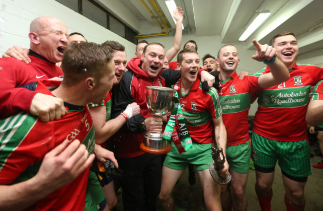 Paul Curran celebrates with his team in the dressing room after the game