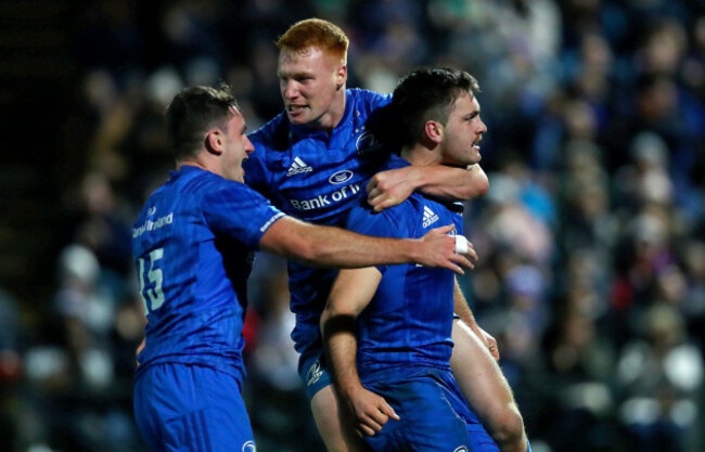 Conor O'Brien celebrates scoring a try with Ciaran Frawley and Hugo Keenan