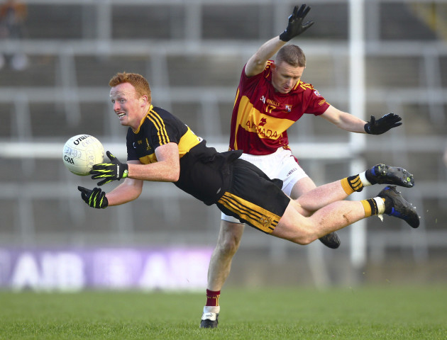 Johnny Buckley tackled by Eoin Curtin
