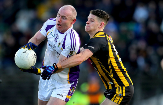 Cathal Finn challenges Pat Burke for the ball.