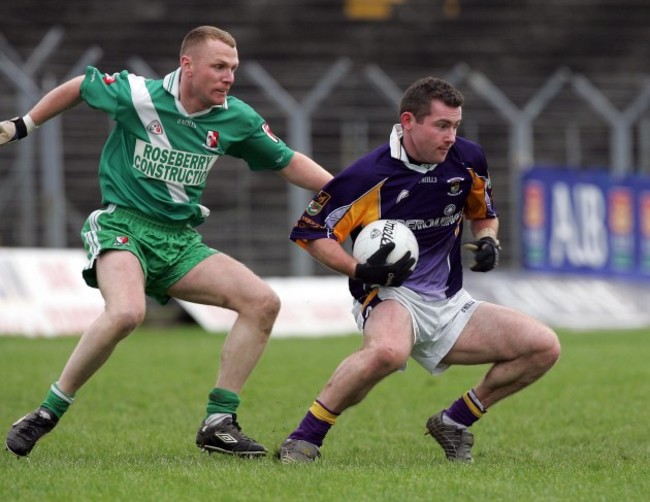 Nigel Campbell of Sarsfields chases Pat Burke of Kilmacud Crokes