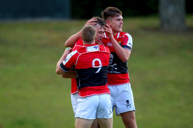 James Taylor celebrates scoring a try with Mark Bissesar and John Poland