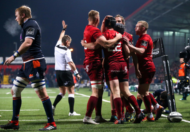 Tyler Bleyendaal celebrates scoring a try with teammates