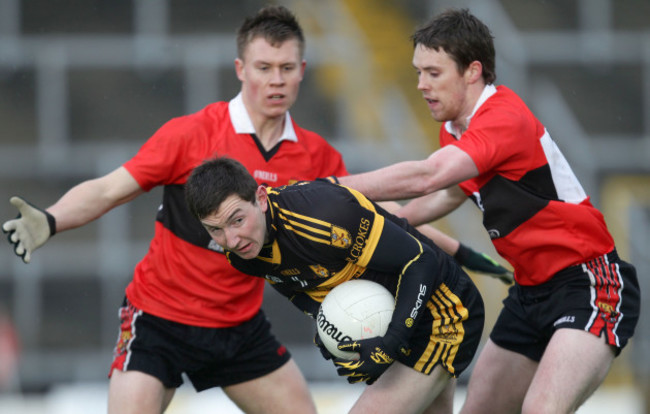 Daithi Casey under pressure from Niall Daly and Sean Kiely