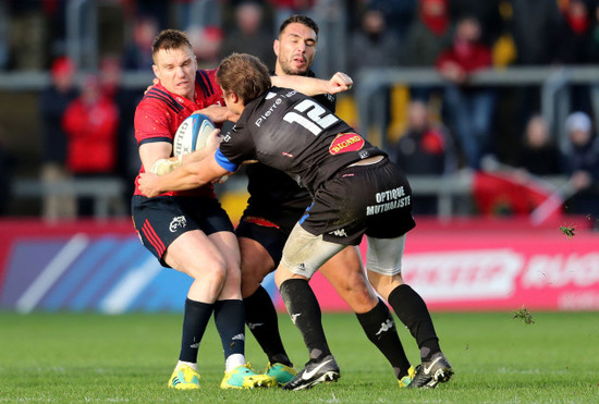 Rory Scannell tackled by Florian Vialelle and Ludovic Radosavljevic