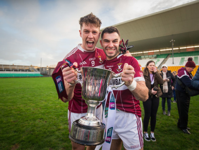 John Kegan and Simon Cadam celebrate with the trophy after the game