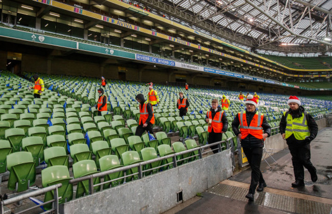 Stewards wearing Christmas hats perform final checks before the game