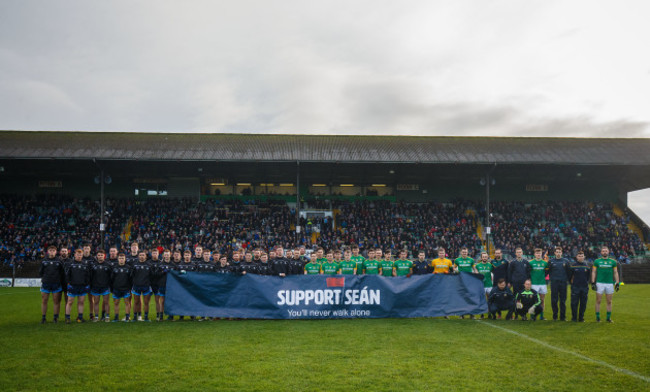 Both teams hold up a sign in support of Sean Cox before the game