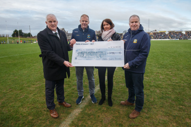 Martina Cox is presented with a cheque by John Kavanagh, Fergus McNulty and Peter O'Halloran