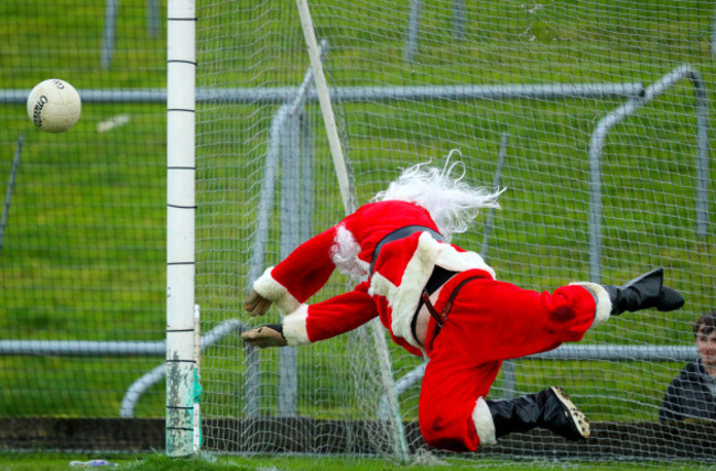 Santa Claus saves a penalty during a shoot out at half time