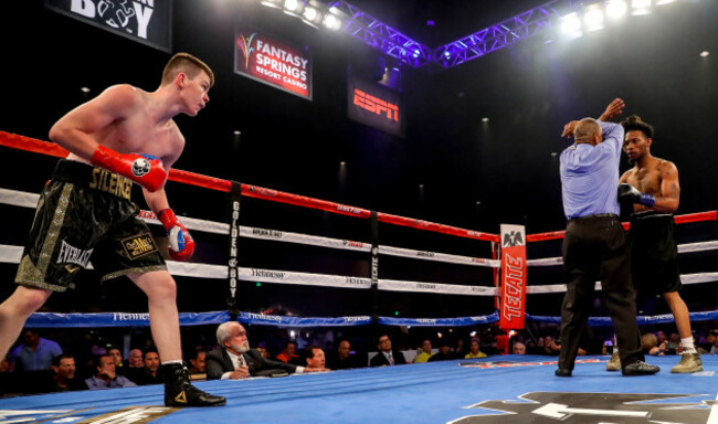 Aaron McKenna looks on as the referee waves off the fight