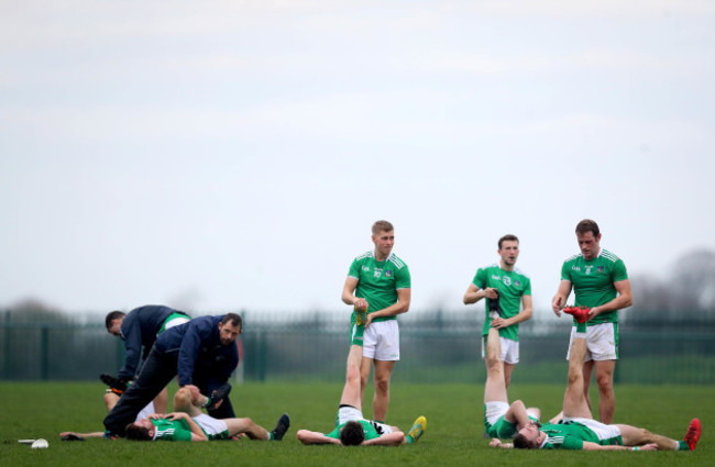 Limerick players stretch after the game
