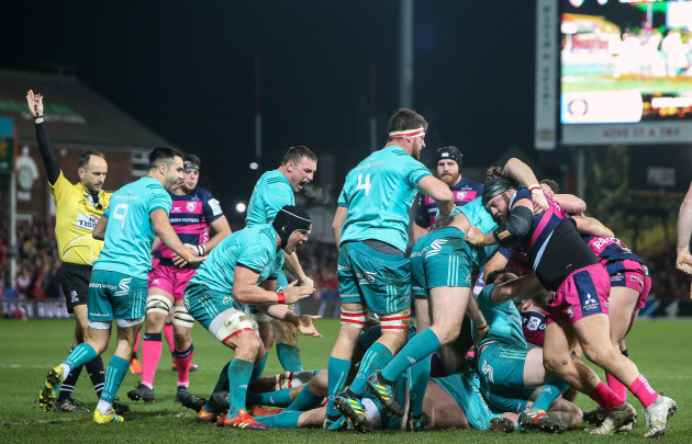 Munster players celebrate after being awarded a scrum penalty by referee Romain Poite