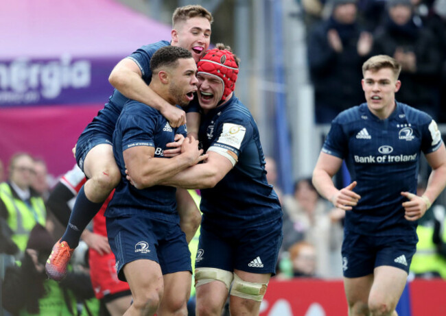 Adam Byrne celebrates his try with Jordan Larmour and Josh van der Flier