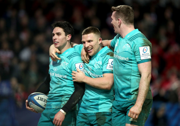 Joey Carbery celebrates scoring his second try with Andrew Conway and Chris Farrell