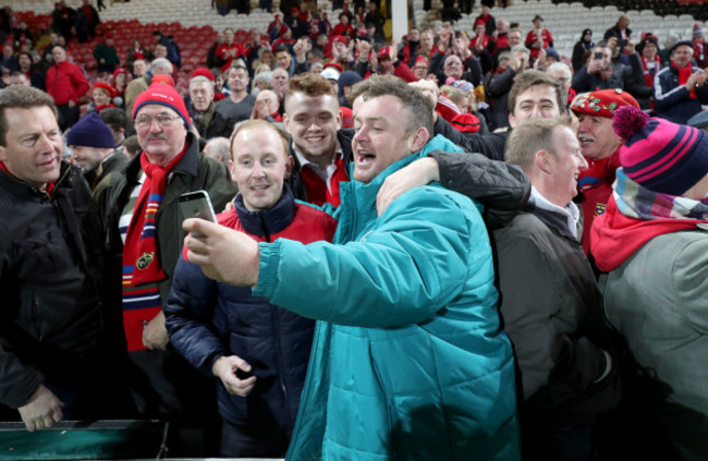 Dave Kilcoyne poses for pictures with fans after the game