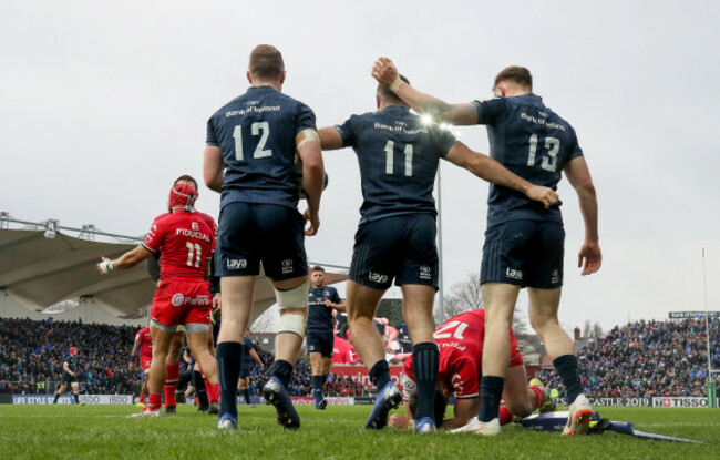 Dave Kearney celebrates his try with Rory O'Loughlin and Garry Ringrose