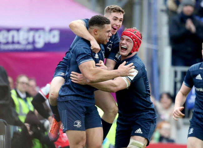 Adam Byrne celebrates his try with Jordan Larmour and Josh van der Flier