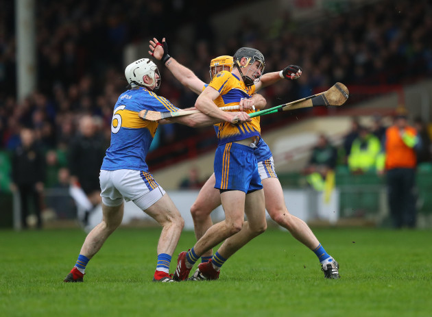 Colin Guilfoyle tackled by Padraic Maher and Seamus Kennedy